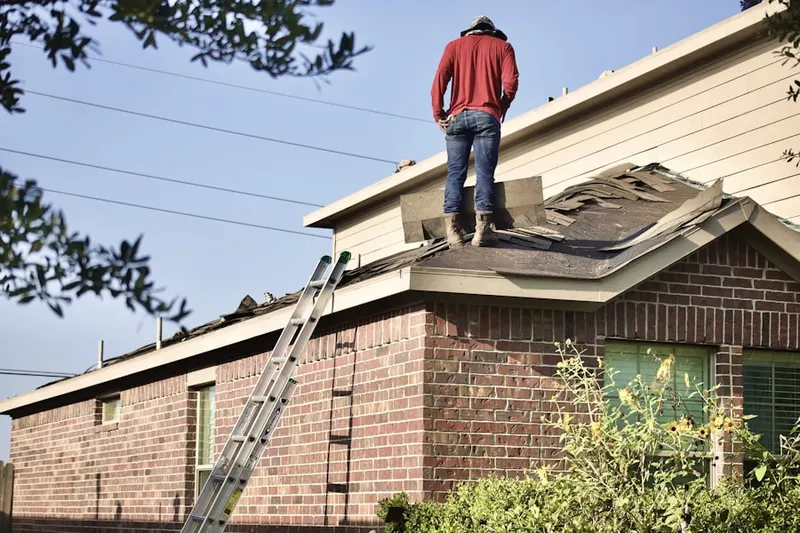 Professional roofer working on a residential roof in Windy Acres
